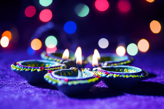 Clay diya lamps lit during Diwali Celebration. Greetings Card Design Indian Hindu Light Festival called Diwali