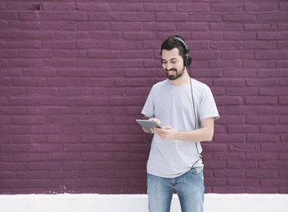 Young latin man using a tablet