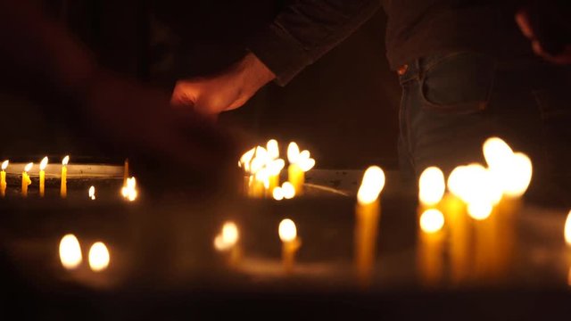 People light candles in the Christian Church on the altar. Close-up