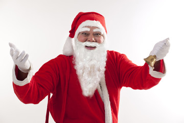 Happy Santa Claus greeting with bell over white background 