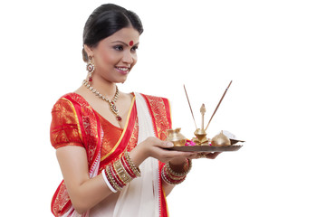 Bengali woman holding a puja thali