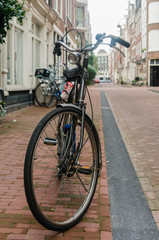 A bicycle parked on the footpath on a street in Amsterdam