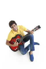 Portrait of a young man playing a guitar