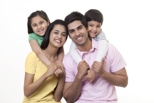 Portrait of a Indian family smiling over white background 