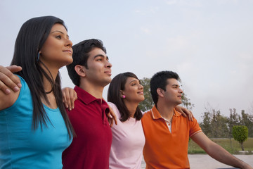 Thoughtful friends looking away outdoors