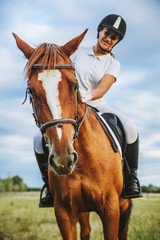 Fototapeta premium Girl jockey riding a horse