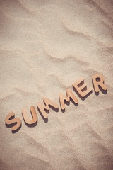 Summer. Wooden letters on the sand