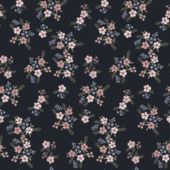 Floral seamless pattern of small flowers in pastel colors on a dark blue background