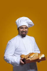 Portrait of chef with tray of bread