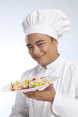 Portrait of chef with plate of noodles