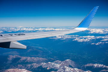 Wing of an airplane against a background in the sky. Shevelev.