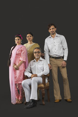 Portrait of Indian two generation family in retro 70s clothing