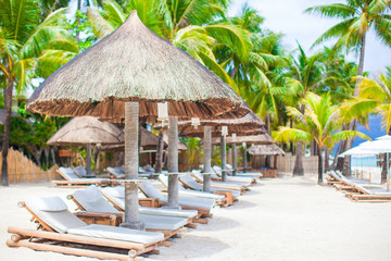 Fototapeta premium Beach beds on luxury resort on exotic tropical white sandy beach