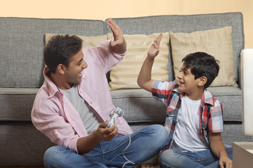 Father and Son Playing Video Game © IndiaPix