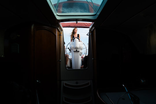 Woman posing at steering wheel