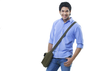 Young college student standing over white background 