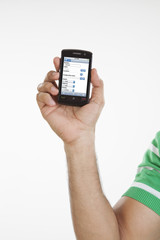 Close-up of hand holding mobile phone