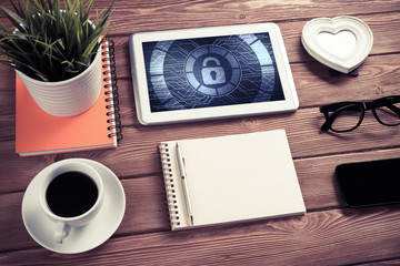 Web security and technology concept with tablet pc on wooden tab