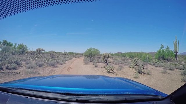 A forward perspective of driving off-road on the trails in Arizona on a sunny summer day. Shot at 60fps.  	