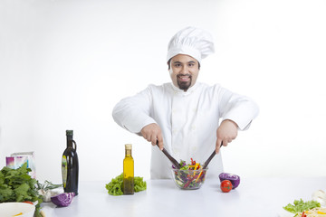 Portrait of chef mixing vegetables in bowl