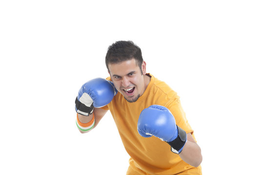 Portrait of young male boxer in a fighting stance over white background 