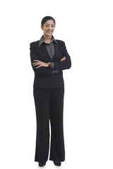 Obraz na płótnie Canvas Full length portrait of confident businesswoman with arms crossed standing against white background 