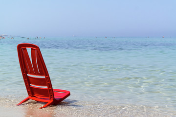 Fototapeta na wymiar One day at the sea with the red chair