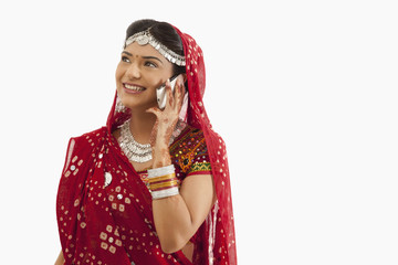 Female dandiya dancer talking on a mobile phone 