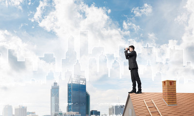 Businessman standing on roof and looking in binoculars. Mixed media