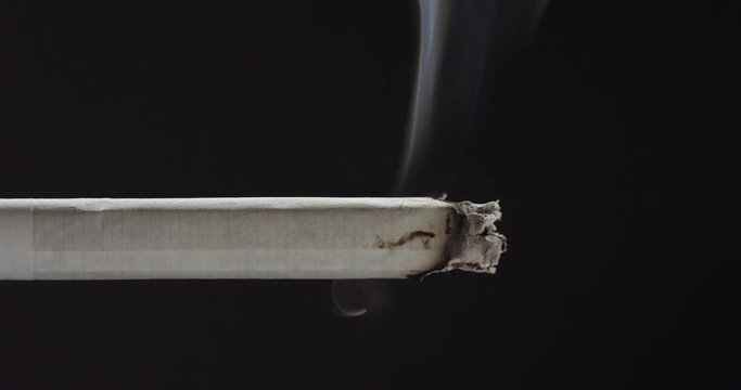 Slow motion, person lights cigarette with lighter