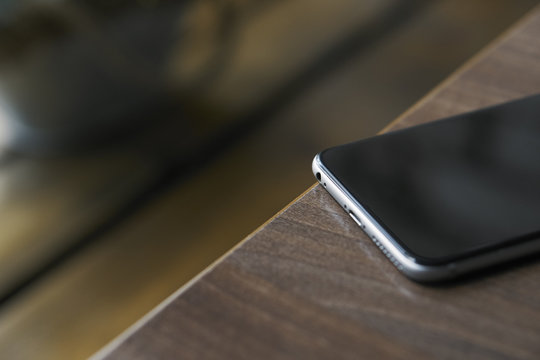 Close-up of the phone lies on a wooden table