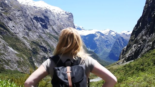 Slow motion, young blonde woman backpacking New Zeland travel lifestyle