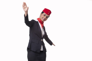 Portrait of young air hostess with arms outstretched isolated over white background 