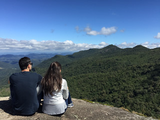 Couple at the top of  a mountain in  Monte Verde, Minas Gerais, Brazil.