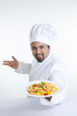Portrait of chef with plate of pasta