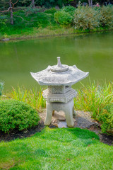 japanese stone lantern by pond