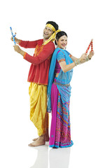 Gujarati couple performing dandiya dance 