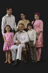 Portrait of smiling Indian multi-generation family dressed in retro style