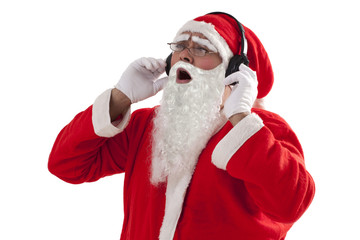 Santa Claus enjoying music from headset over white background 