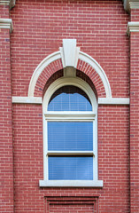 Classical court house window on a brick building.