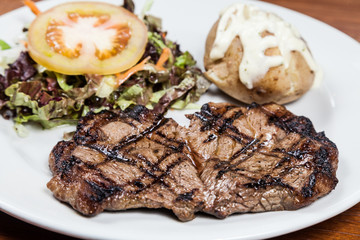 Roast beef steak with potato and salad