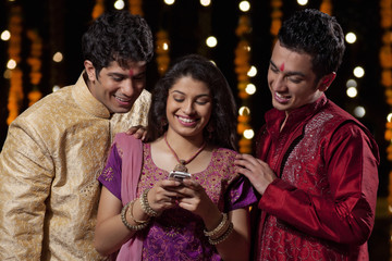 Friends reading an sms on a mobile phone