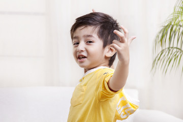 Portrait of cute little boy gesturing 