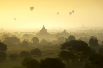  Hot air balloons fly over the pagoda ancient city field on silhouette sunrise scene at Bagan Myanmar. © Sakrapee Nopparat