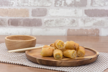Fried Spring Roll on wooden plate with sauce