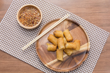 Fried Spring Roll on wooden plate with sauce