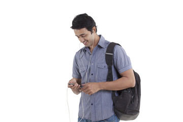 Smiling young man listening to music 