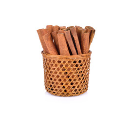 dried cinnamon in basket and on white background