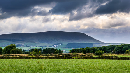 Distance view from farm on Pendle Hill on cloudy summer afternoon