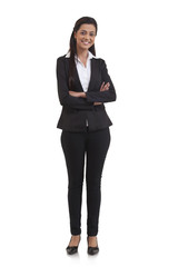 Full length portrait of confident businesswoman with arms crossed isolated over white background 
